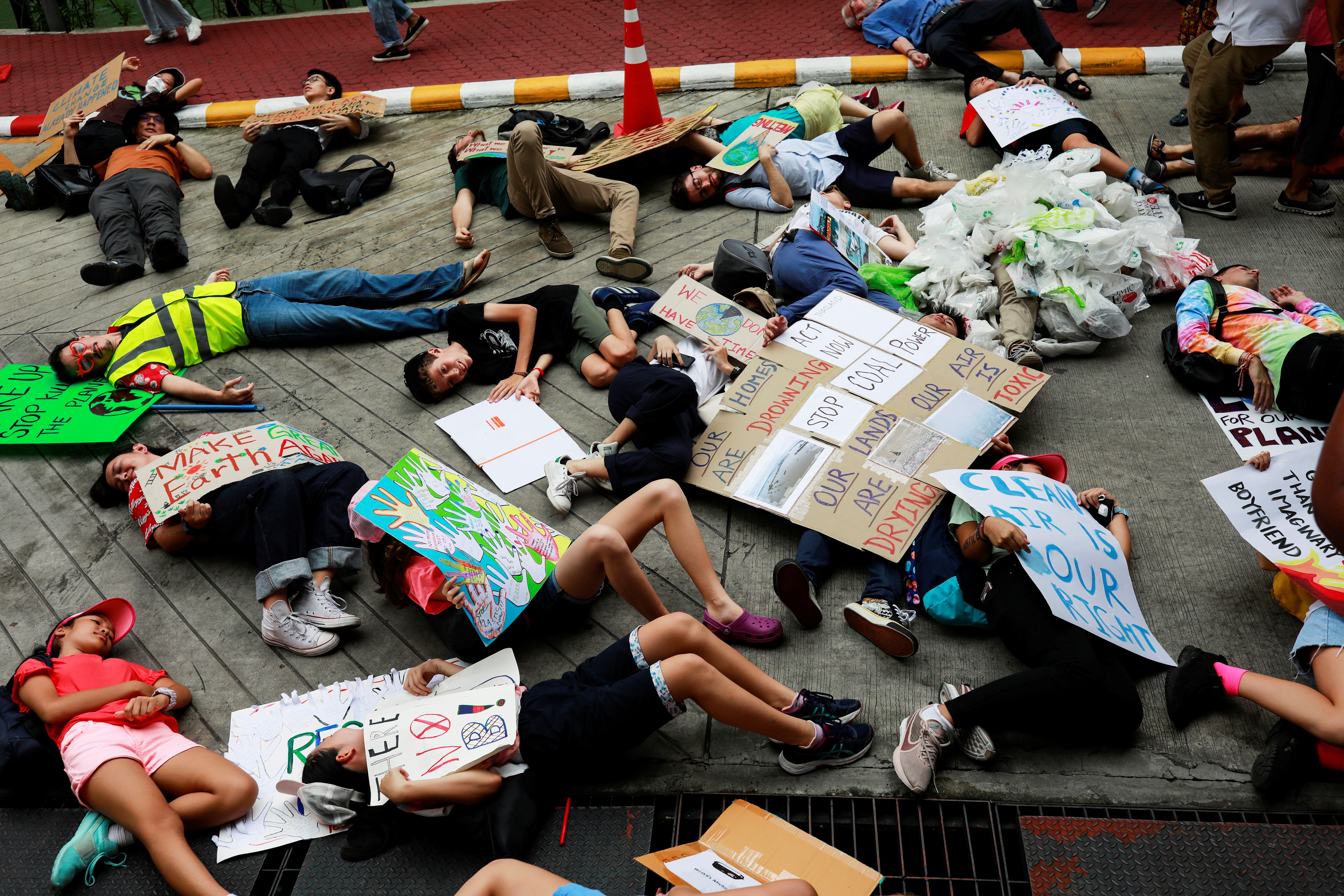 Activistas se tiran al suelo fingiendo que están muertos mientras participan de la 4ª huelga mundial por el clima cerca de la oficina del Ministerio de Recursos Naturales y Medio Ambiente en Bangkok, Tailandia, el 20 de septiembre de 2019. REUTERS/Soe Zeya Tun