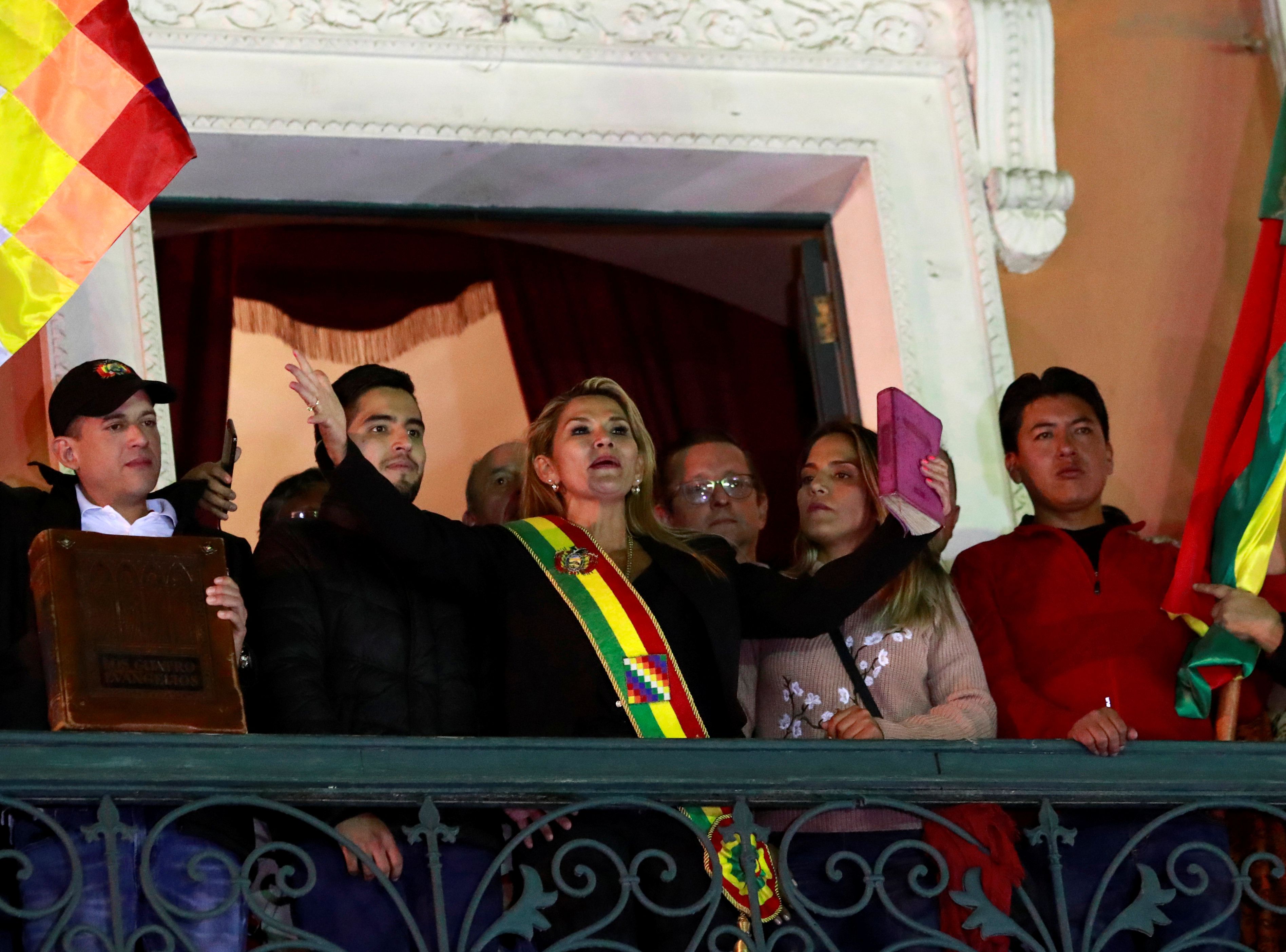 Bolivian Senator Jeanine Anez gestures after she declared herself as Interim President of Bolivia, at the balcony of the Presidential Palace, in La Paz, Bolivia November 12, 2019. REUTERS/Henry Romero