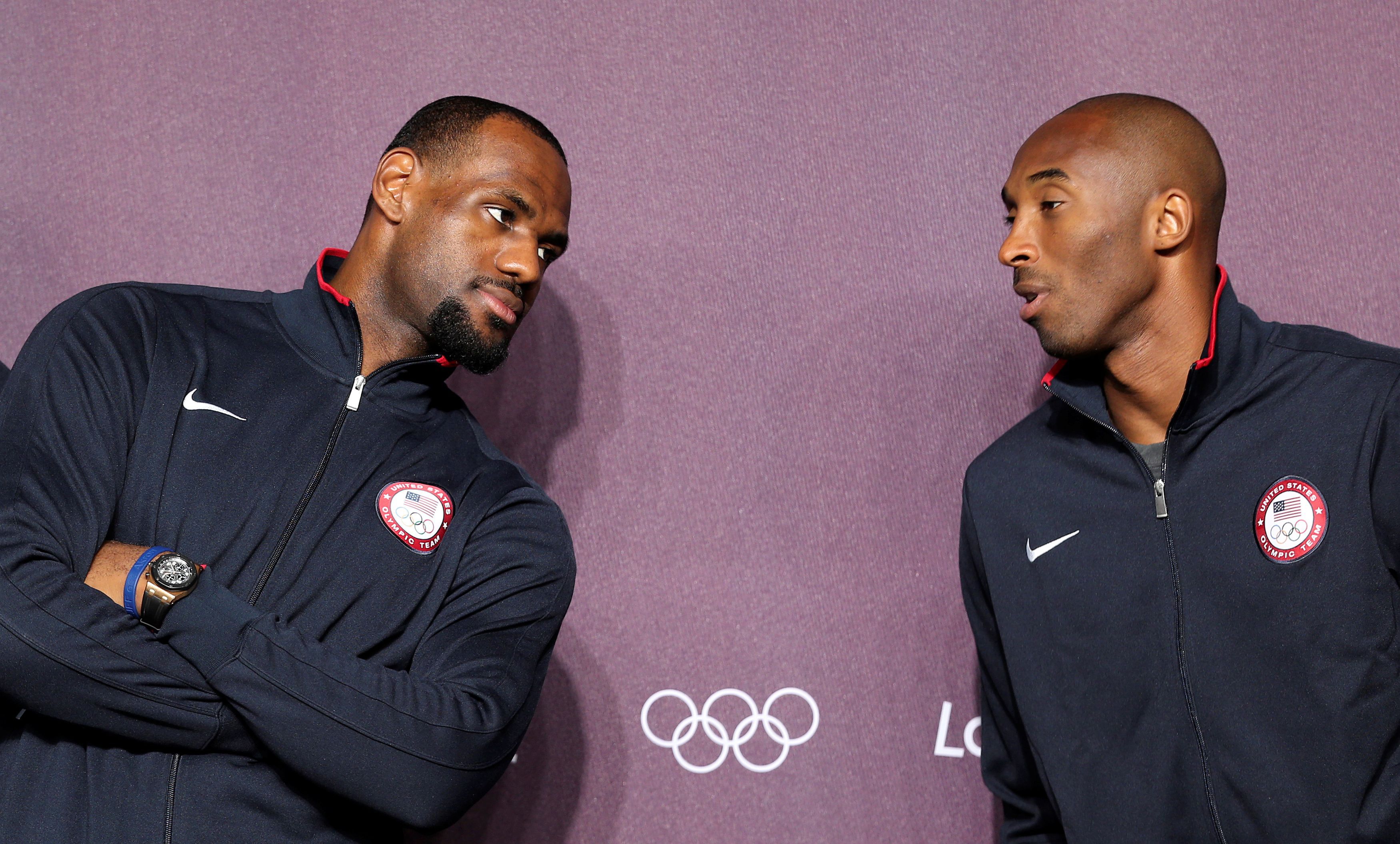 FILE PHOTO: U.S. basketball player Kobe Bryant (R) talks with his teammate LeBron James during a news conference in the Olympic media centre before the start of the London 2012 Olympic Games, Britain July 27, 2012. REUTERS/Stefano Rellandini/File Photo