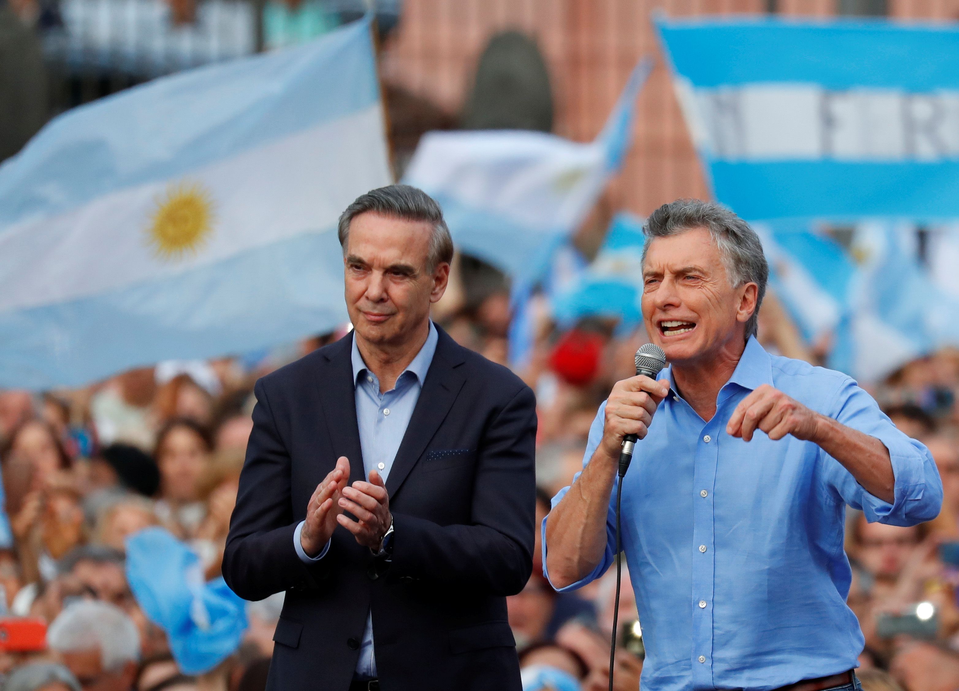 Argentina's outgoing president Mauricio Macri and his running mate Miguel Angel Pichetto greet supporters outside the Casa Rosada presidential palace during a rally in Buenos Aires, Argentina, December 7, 2019. REUTERS/Agustin Marcarian