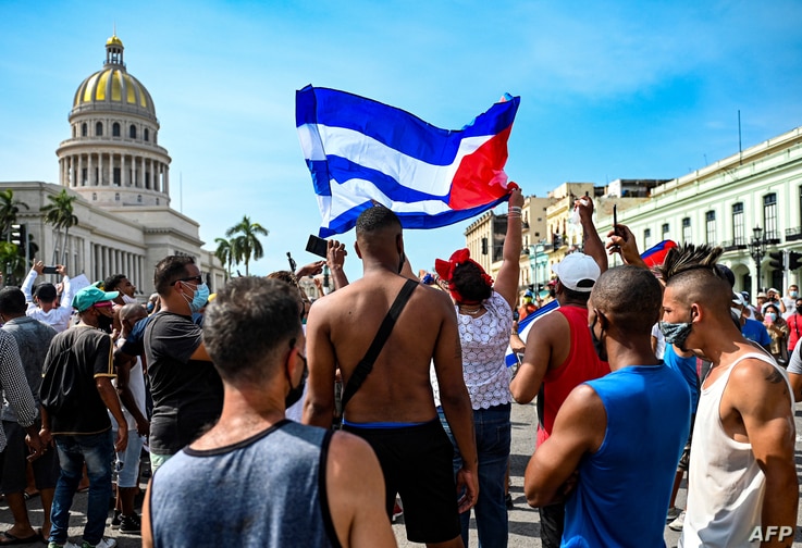 Cubans are seen outside Havana's Capitol during a demonstration against the government of Cuban President Miguel Diaz-Canel in…