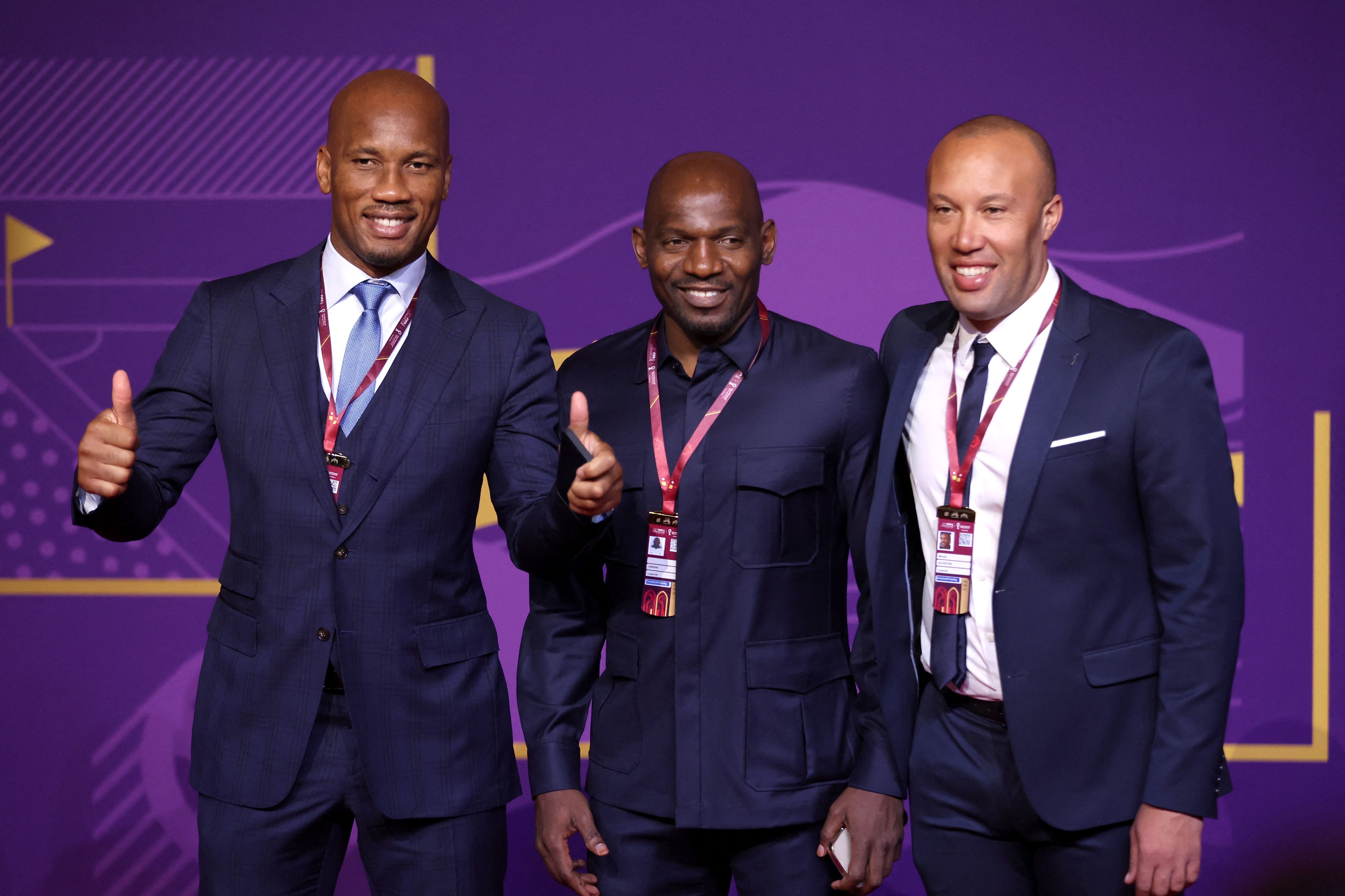 Soccer Football - World Cup - Final Draw - Doha Exhibition & Convention Center, Doha, Qatar - April 1, 2022 Former player Didier Drogba, Geremi and Mikael Silvestre arrive ahead of the draw REUTERS/Carl Recine